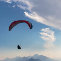 Parachute and human silhouette. Blu sky adventure. blue sky, parachute and human silhouette. adventure