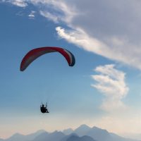 blue sky, parachute and human silhouette. adventure